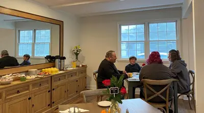 a group of people sitting at a table in a restaurant at Arcady Mountain Motor Lodge in Sunderland