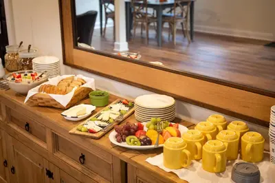 a breakfast buffet with food on a wooden table at Arcady Mountain Motor Lodge in Sunderland