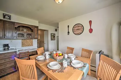 a dining room with a table and chairs and a kitchen at Albany Home with Fenced Yard and Patio - Pets Welcome! in Albany