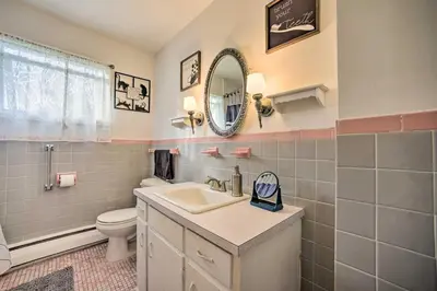 a bathroom with a sink and a toilet and a mirror at Albany Home with Fenced Yard and Patio - Pets Welcome! in Albany