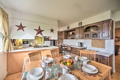 a kitchen and dining room with a table and chairs at Albany Home with Fenced Yard and Patio - Pets Welcome! in Albany