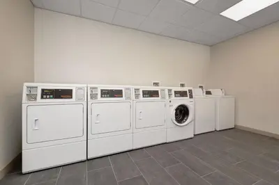 a room with four washing machines and a washer and dryer at Element New York Wood Ridge in Wood-Ridge