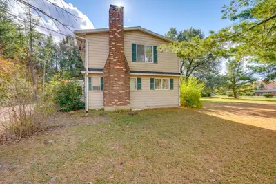 an empty yard in front of a house with a brick chimney at Relaxing Catskills Apt Less Than 3 Mi to Windham Mountain! in Windham