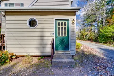 a small house with a green door on a road at Relaxing Catskills Apt Less Than 3 Mi to Windham Mountain! in Windham