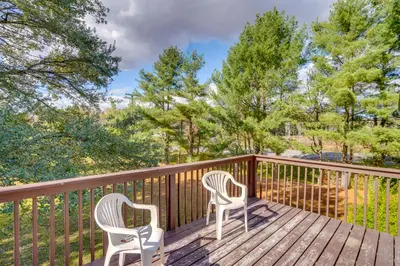 two chairs sitting on a deck with trees at Relaxing Catskills Apt Less Than 3 Mi to Windham Mountain! in Windham