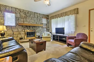 a living room with a couch and a stone wall at Spacious Apt with Yard 3 Mi to Windham Mountain in Windham