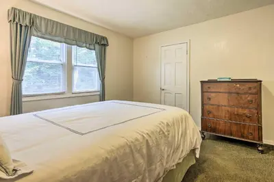 a bedroom with a bed and a dresser and a window at Spacious Apt with Yard 3 Mi to Windham Mountain in Windham