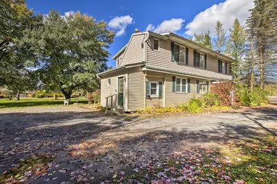a house on a dirt road next to a driveway at Spacious Apt with Yard 3 Mi to Windham Mountain in Windham