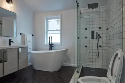 a bathroom with a tub and a toilet and a shower at Holly Lodge - Ski Windham Hunter Catskills in Prattsville