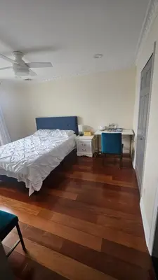 a bedroom with a bed and a table and a desk at Luxury Hotel-Style Room in Queens, New York in Bayside