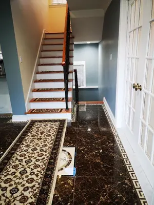a hallway with a tile floor and stairs with a door at Luxury Hotel-Style Room in Queens, New York in Bayside