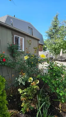 a house with a garden with flowers in front of it at Luxury Hotel-Style Room in Queens, New York in Bayside
