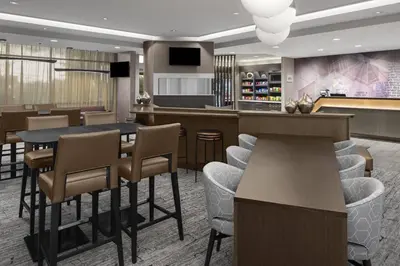 a lobby with a bar and a restaurant with stools at SpringHill Suites by Marriott East Rutherford Meadowlands Carlstadt in Carlstadt