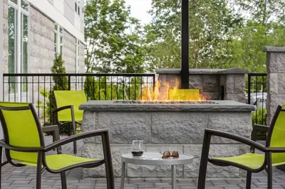 a patio with chairs and a fire pit at SpringHill Suites by Marriott East Rutherford Meadowlands Carlstadt in Carlstadt