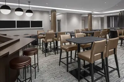 a restaurant with tables and chairs in a room at SpringHill Suites by Marriott East Rutherford Meadowlands Carlstadt in Carlstadt