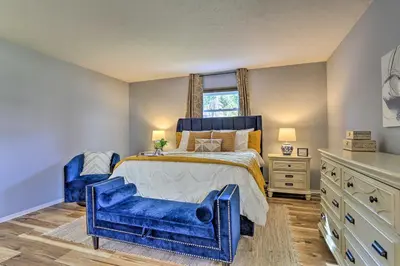 a bedroom with blue furniture and a bed and a window at Hot Tub, Fire Pit and Resort Perks Tobyhanna Home! in Tobyhanna