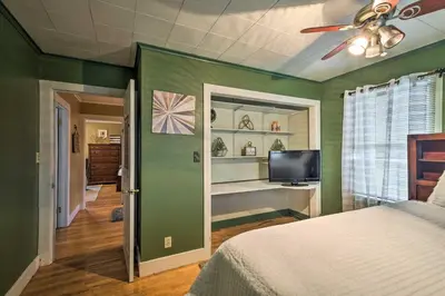 a bedroom with green walls and a bed and a tv at Stylish Suburban Getaway, 10 Miles to Royal Mtn! in Johnstown