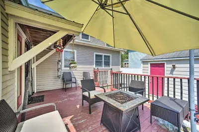 a patio with a table and an umbrella at Stylish Suburban Getaway, 10 Miles to Royal Mtn! in Johnstown