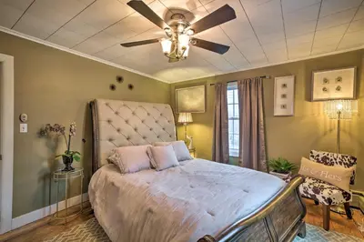 a bedroom with a bed with a ceiling fan at Stylish Suburban Getaway, 10 Miles to Royal Mtn! in Johnstown
