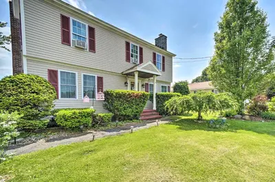 a white house with red shutters and a yard at Stylish Suburban Getaway, 10 Miles to Royal Mtn! in Johnstown