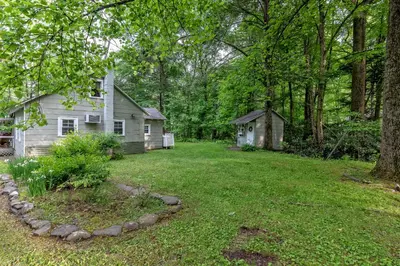 a yard with a small house and a yard at Camelback cottage - on ONE ACRE & near local attractions in Tannersville