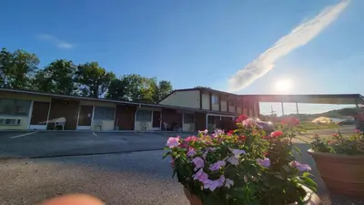 a hotel with flowers in front of a building at Sussex Motel in Wantage