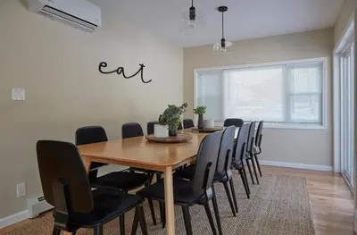 a dining room with a wooden table and chairs at Chateau Lodge - Ski Shandaken, Hunter, Catskills, Windham, Belleayre in Shandaken