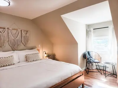 a bedroom with a large bed and a window at Chateau Lodge - Ski Shandaken, Hunter, Catskills, Windham, Belleayre in Shandaken