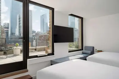 a hotel room with a bed and a large window at Arlo Midtown in New York