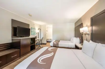a hotel room with a bed and a television at Quality Inn Poughkeepsie in Poughkeepsie