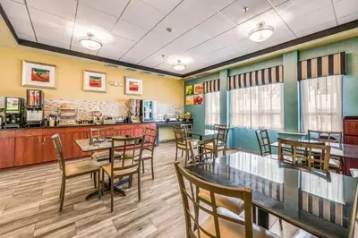 a restaurant with tables and chairs and a counter at Rodeway Inn Poughkeepsie in Poughkeepsie