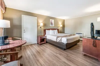 a hotel room with a bed and a television at Rodeway Inn Poughkeepsie in Poughkeepsie