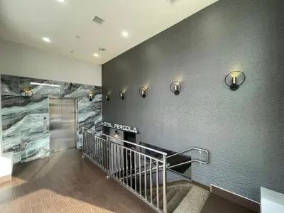 a staircase in a building with a mural on the wall at Hotel Pergola Jamaica JFK in Queens