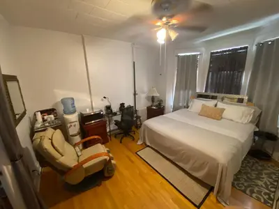 a bedroom with a bed and a chair in it at Nice 2 bedrooms, Massage Seat, close to New York, THE BEST CHOICE!! in North Bergen