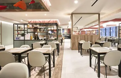 a dining room with tables and chairs in a restaurant at Riu Plaza Manhattan Times Square in New York