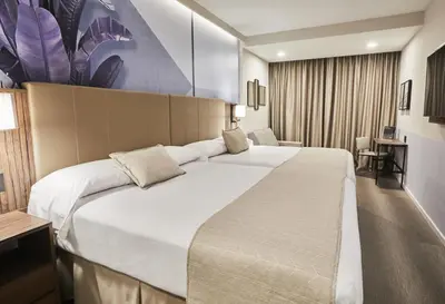 a bedroom with a large white bed in a room at Riu Plaza Manhattan Times Square in New York