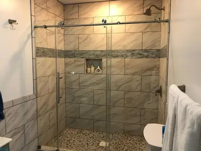 a shower with a glass door in a bathroom at 1st Class Rentals Cooperstown New 3 Bedroom House in Cooperstown