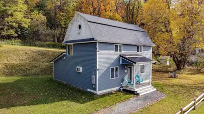a small blue house sitting in a field at 1st Class Rentals Cooperstown New 3 Bedroom House in Cooperstown