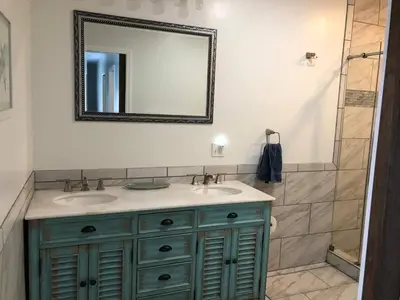 a bathroom with two sinks and a mirror at 1st Class Rentals Cooperstown New 3 Bedroom House in Cooperstown