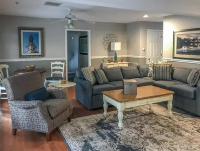 a living room with a couch and a table and chairs at Holiday Inn Club Vacations Oak n Spruce Resort in the Berkshires in South Lee