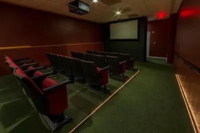 a lecture room with red chairs and a screen at Holiday Inn Club Vacations Oak n Spruce Resort in the Berkshires in South Lee