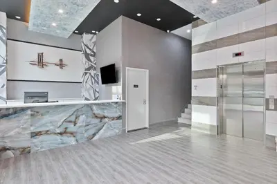 an office lobby with a stone wall at Casa Blanca Hotel Brooklyn Downtown in Brooklyn