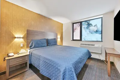a hotel room with a bed and a desk at Casa Blanca Hotel Brooklyn Downtown in Brooklyn