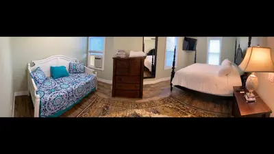 a bedroom with a bed and a mirror at 1st Class Rentals The Thurman Munson House in Cooperstown