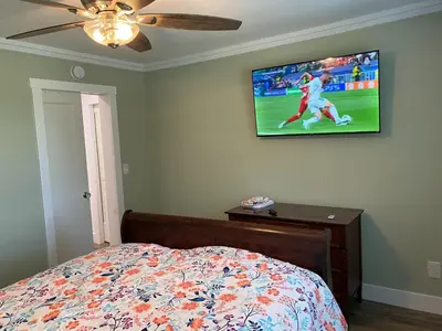 a bedroom with a bed and a tv on the wall at 1st Class Rentals The Thurman Munson House in Cooperstown