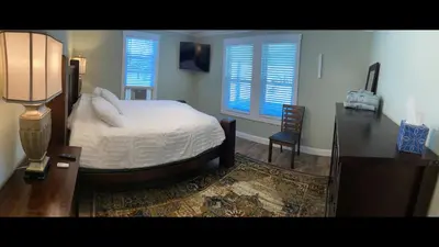 a bedroom with a bed and a table with a lamp at 1st Class Rentals The Thurman Munson House in Cooperstown