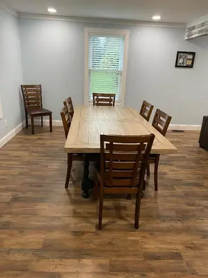 a dining room with a wooden table and chairs at 1st Class Rentals The Thurman Munson House in Cooperstown