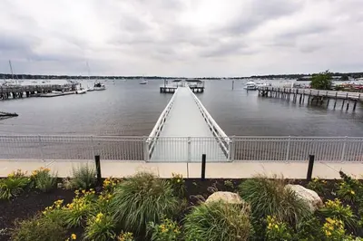 a large body of water with a dock and boats at Fathoms Hotel & Marina in Port Washington