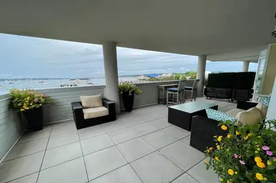 a balcony with furniture and a view of the ocean at Fathoms Hotel & Marina in Port Washington