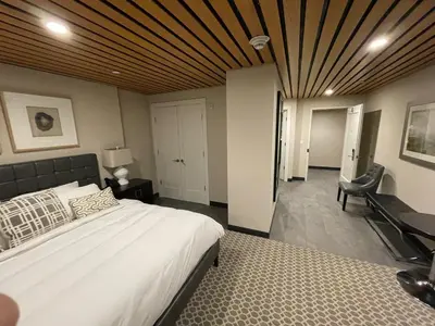 a bedroom with a bed and a desk and a chair at Fathoms Hotel & Marina in Port Washington